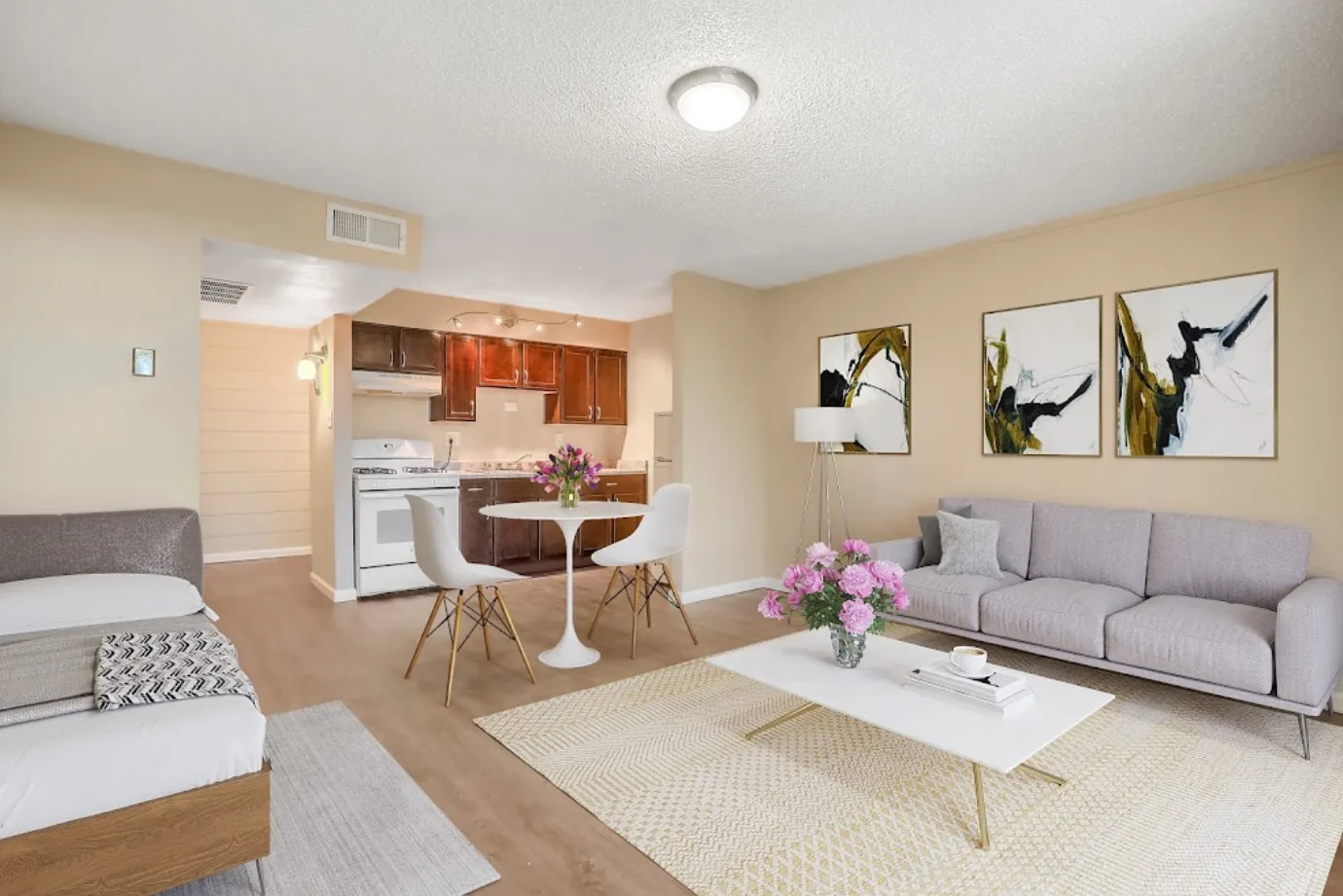 Furnished living room and kitchen with wood-style flooring at Uptown Horizon Apartments