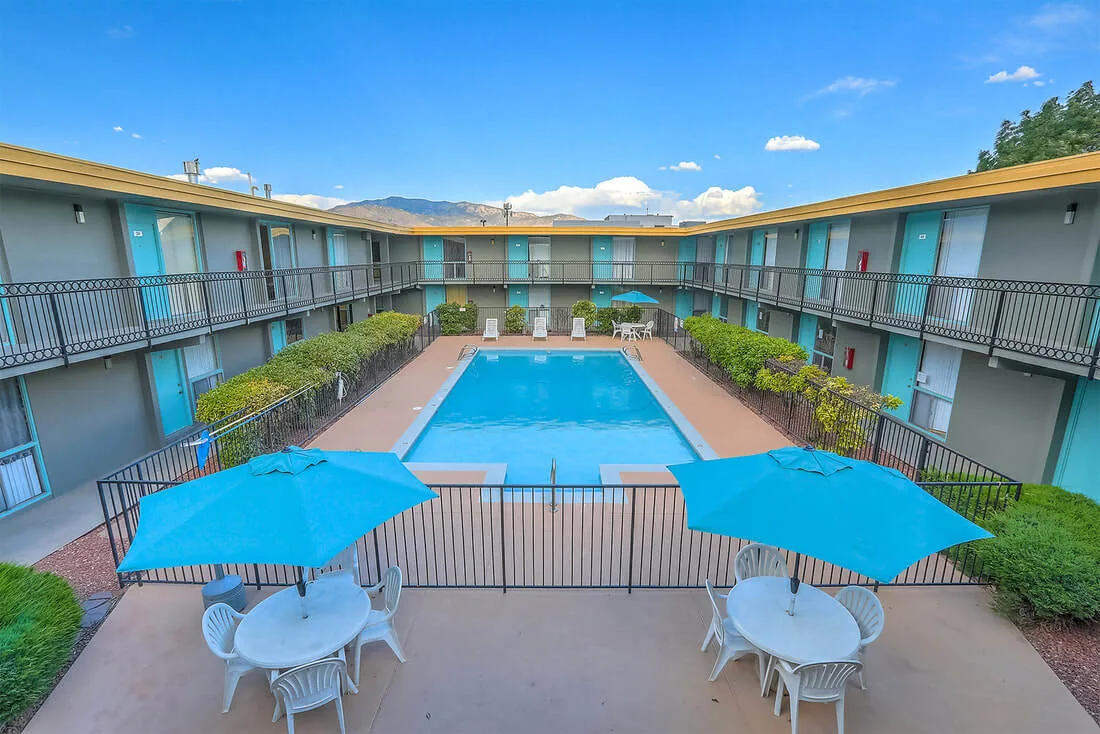 Swimming pool and courtyard with umbrellas at Uptown Horizon Apartments